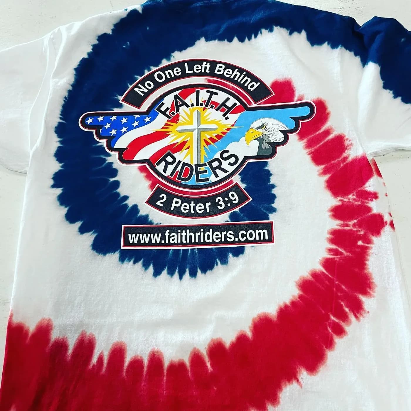Red, white and blue tie-dye t-shirt with a printed multicolor chest design